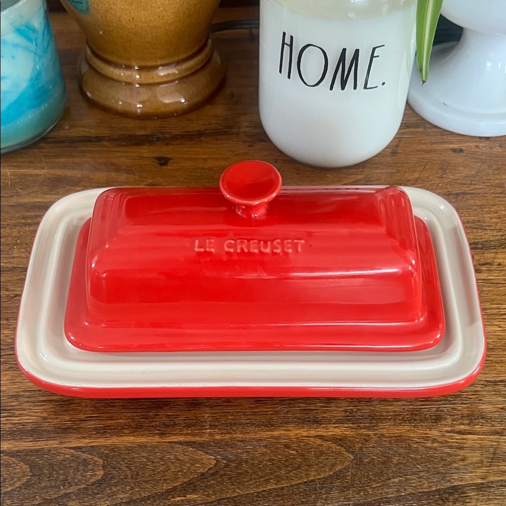 Le Creuset Stoneware Cerise Red Butter Dish with Lid Under Plate